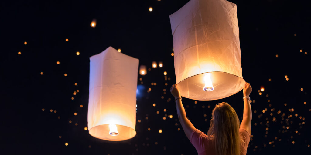Women are releasing floating lanterns in the Loy Krathong festival or floating lanterns festival in Chiang Mai, Thailand.